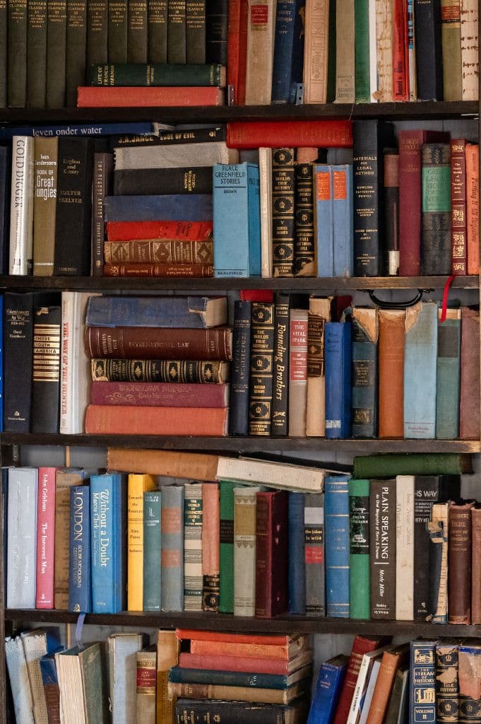 Wall of vintage books concealing the speakeasy entrance