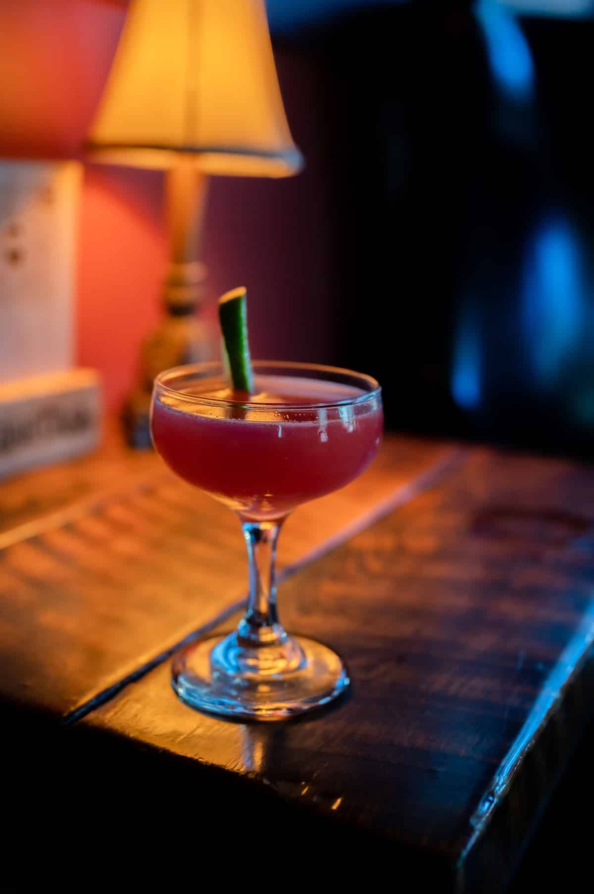 Smoked cocktail under a glass dome at the speakeasy bar
