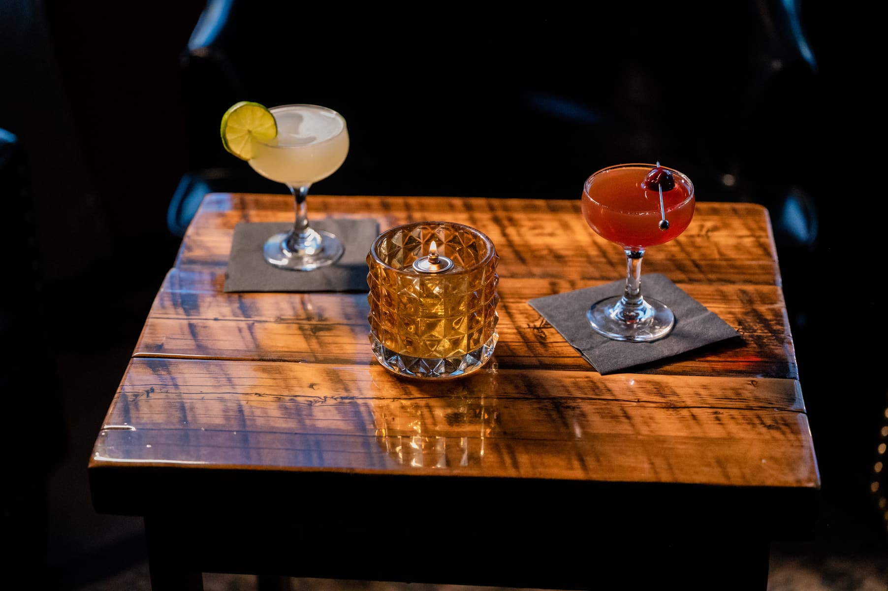Craft cocktail being finished with a garnish at the speakeasy bar