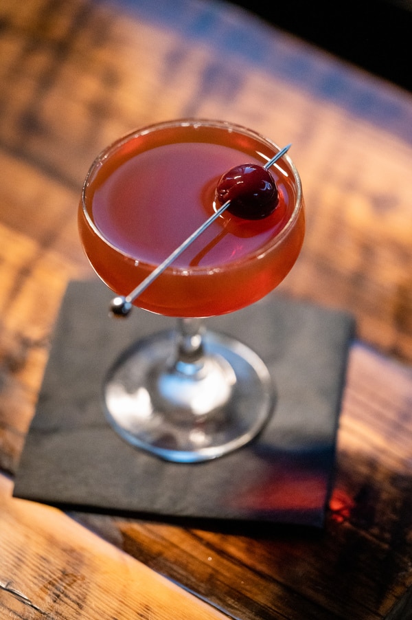 A perfectly crafted Manhattan cocktail, served up with a cherry